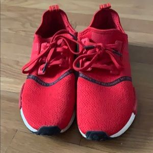 Red and black Adidas NMDs